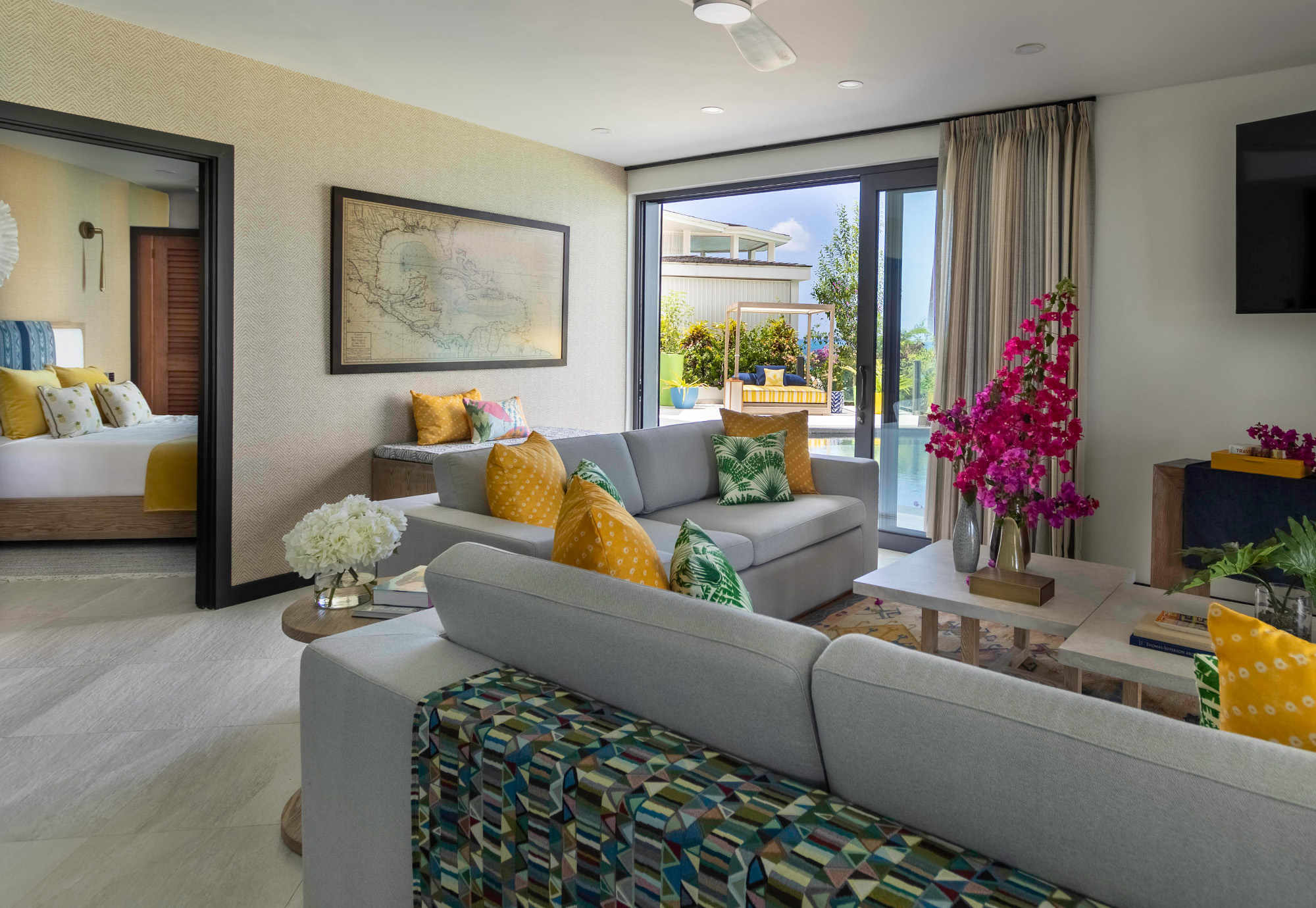 Antigua Tamarind Hills - living room with schumacher textile, vintage maps and phillip jeffries wallpaper, seema Krish textile, christopher farr cloth